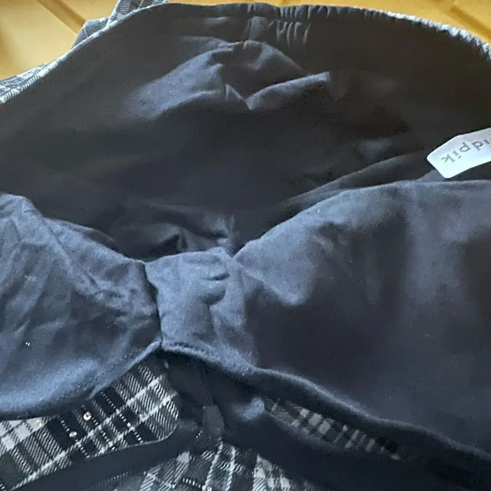 Kidpik Plaid Skirt with attached shorts and bow detail; zipper closure